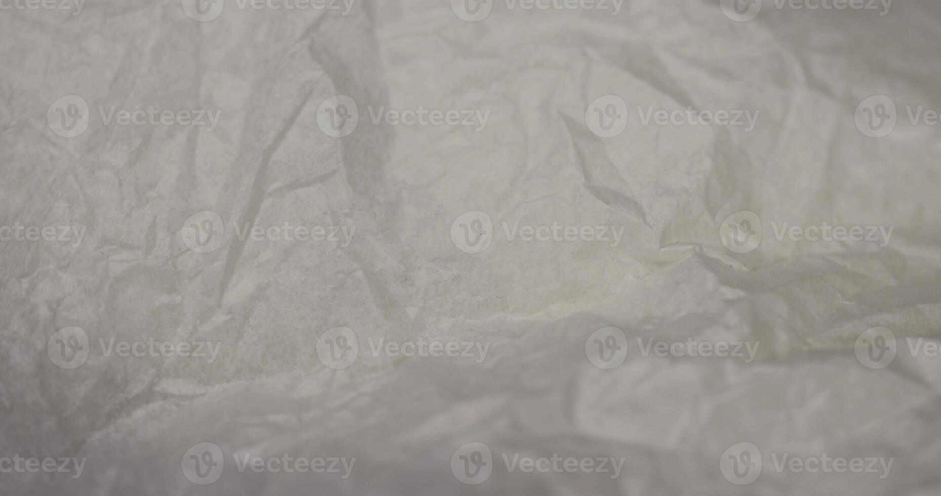 crumpled paper after prolonged use, thin paper made of cellulose as a packaging material for clothing photo
