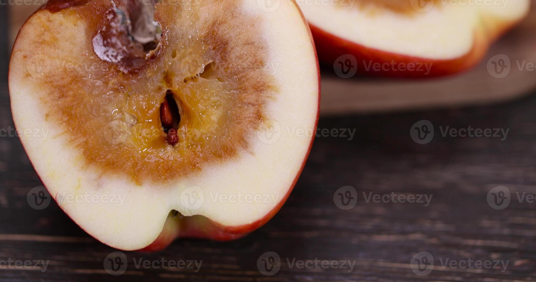 apple that has begun to deteriorate and become covered with rot due to long storage or damage photo