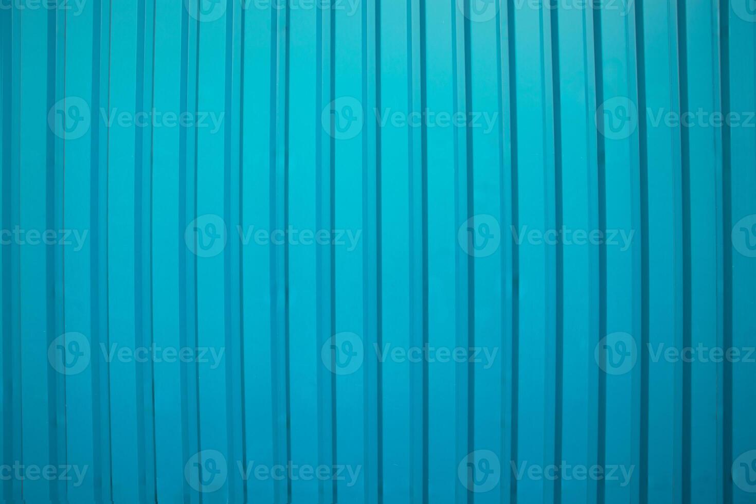 Vertical ridged blue metal surface with subtle shadows, ideal for industrial or architectural backgrounds. photo