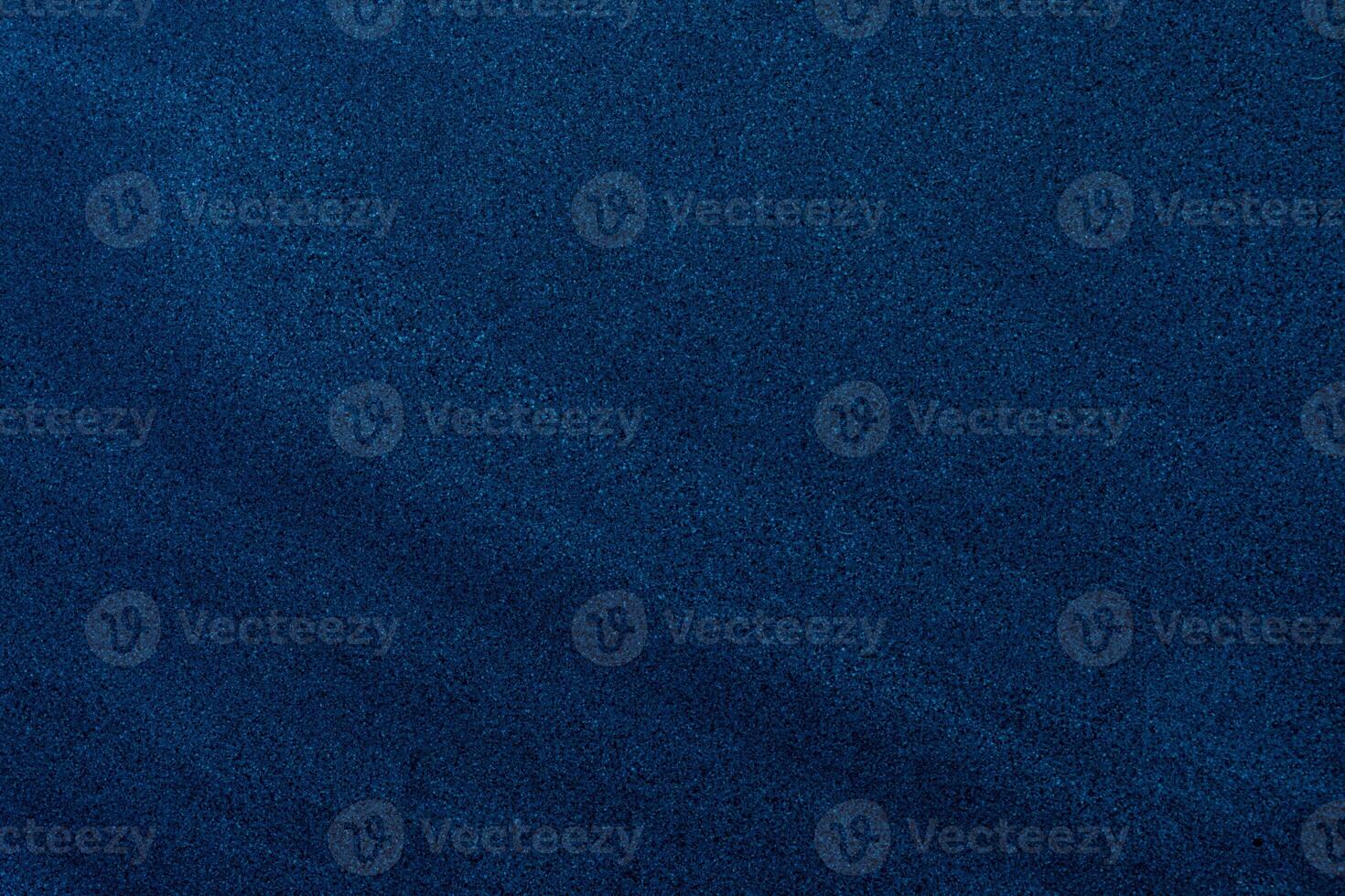 Fine-grain dark blue sand texture with subtle gradients, ideal for backgrounds and design overlays. photo