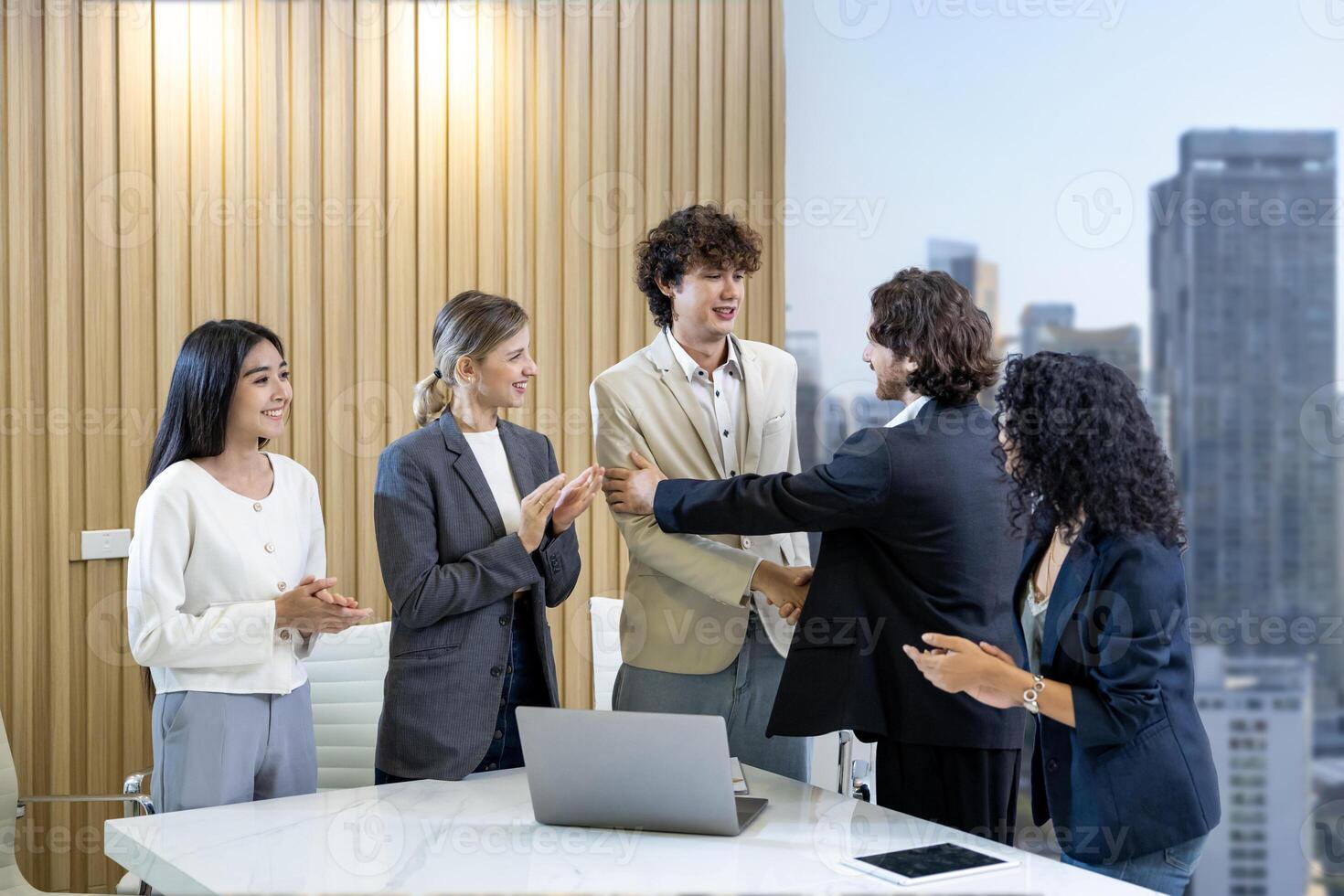 Diversity team of business people having agreement and handshake deal over new strategic strategy project on investment real estate with recognition and applause from other colleague for partnership photo