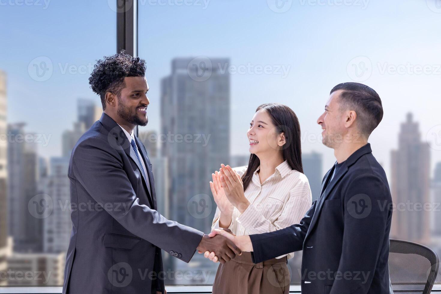 Team of diversity business people having agreement handshake deal over new strategic strategy project on investment real estate with recognition and applause from other colleague for partnership photo