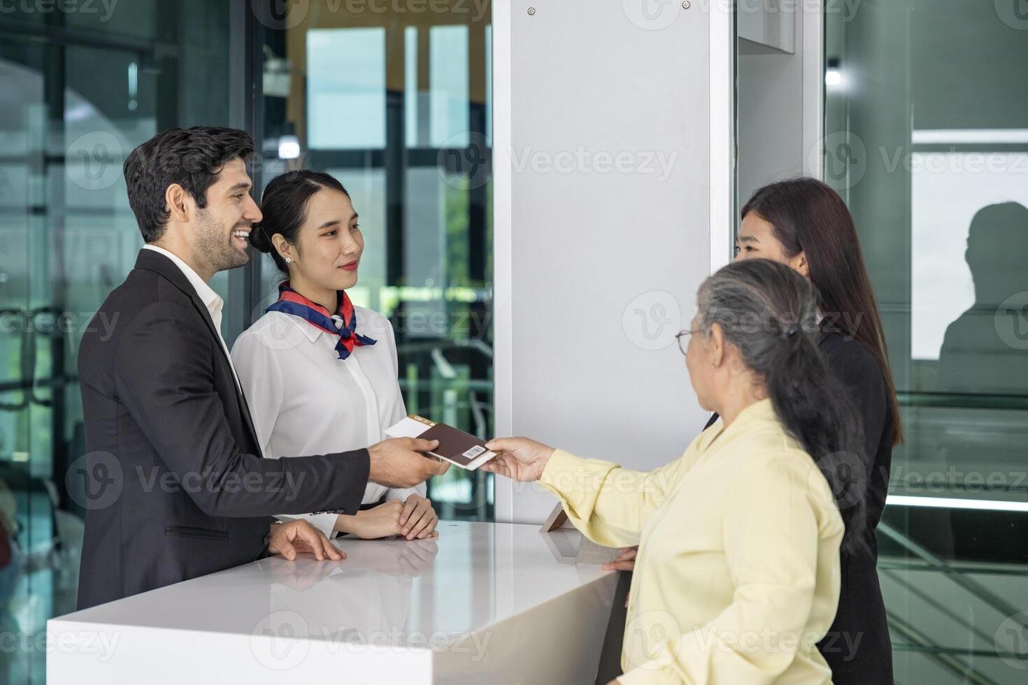 Asian senior passenger is showing their boarding pass to the airline ground crew at departure gate into the airplane for final inspection before boarding into plane photo