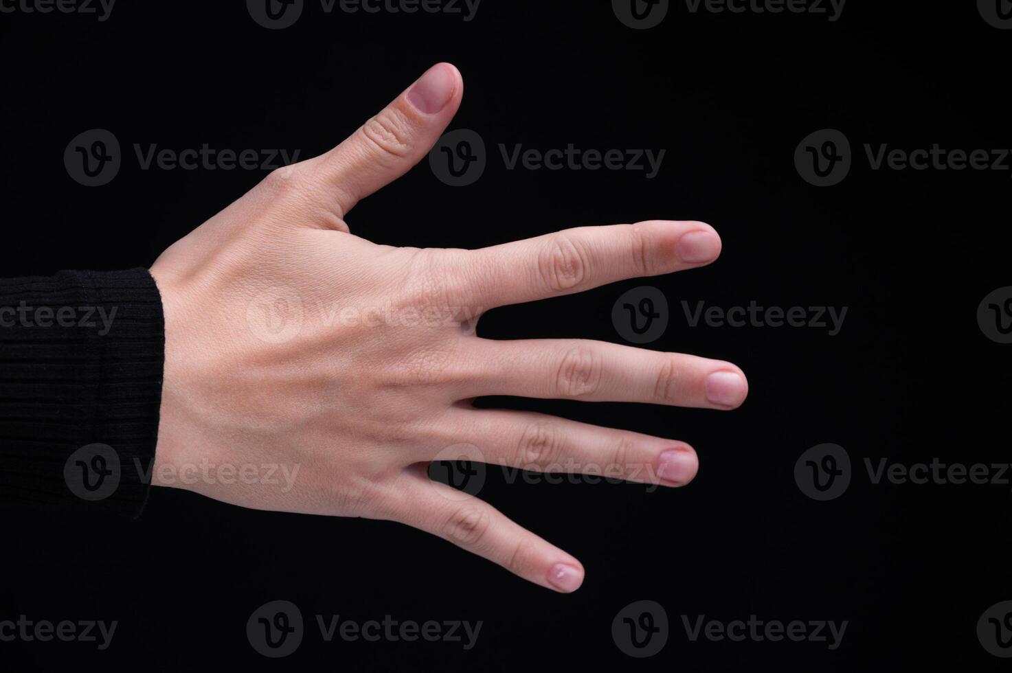 Caucasian woman's female hand back side on black background photo