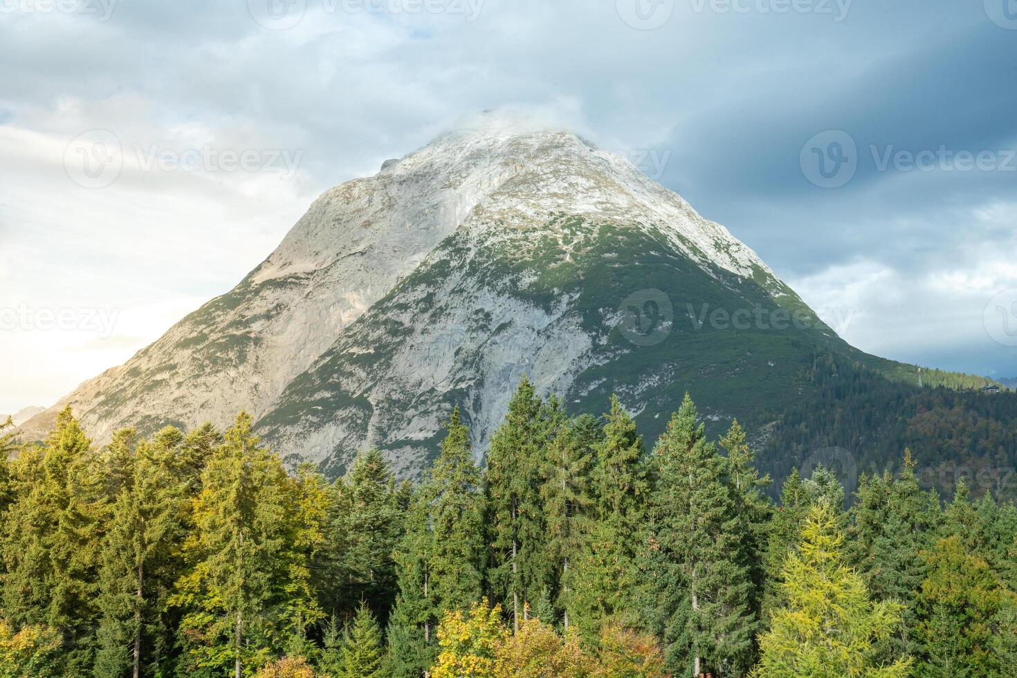 A breathtaking scenic mountain view that is beautifully surrounded by lush. photo
