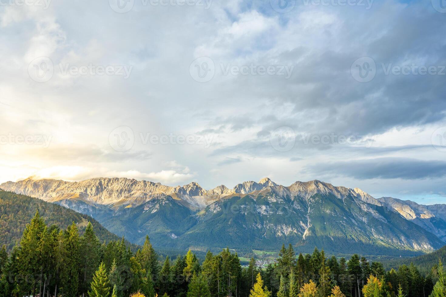 Stunning mountain landscape with lush forests and a dramatic, captivating sky photo