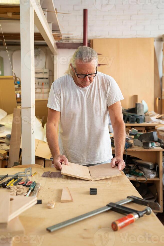 Carpenter working on wood craft at workshop photo