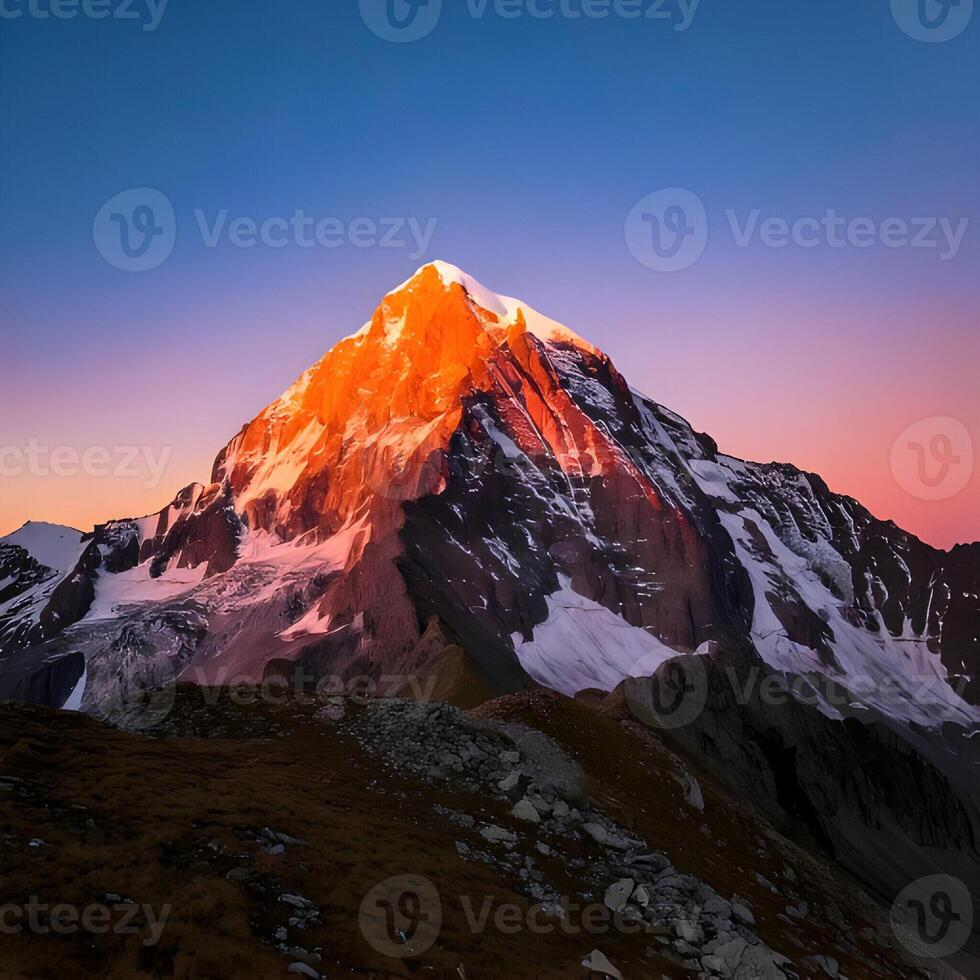 Majestic Snowcapped Mountain Peak at Sunset photo