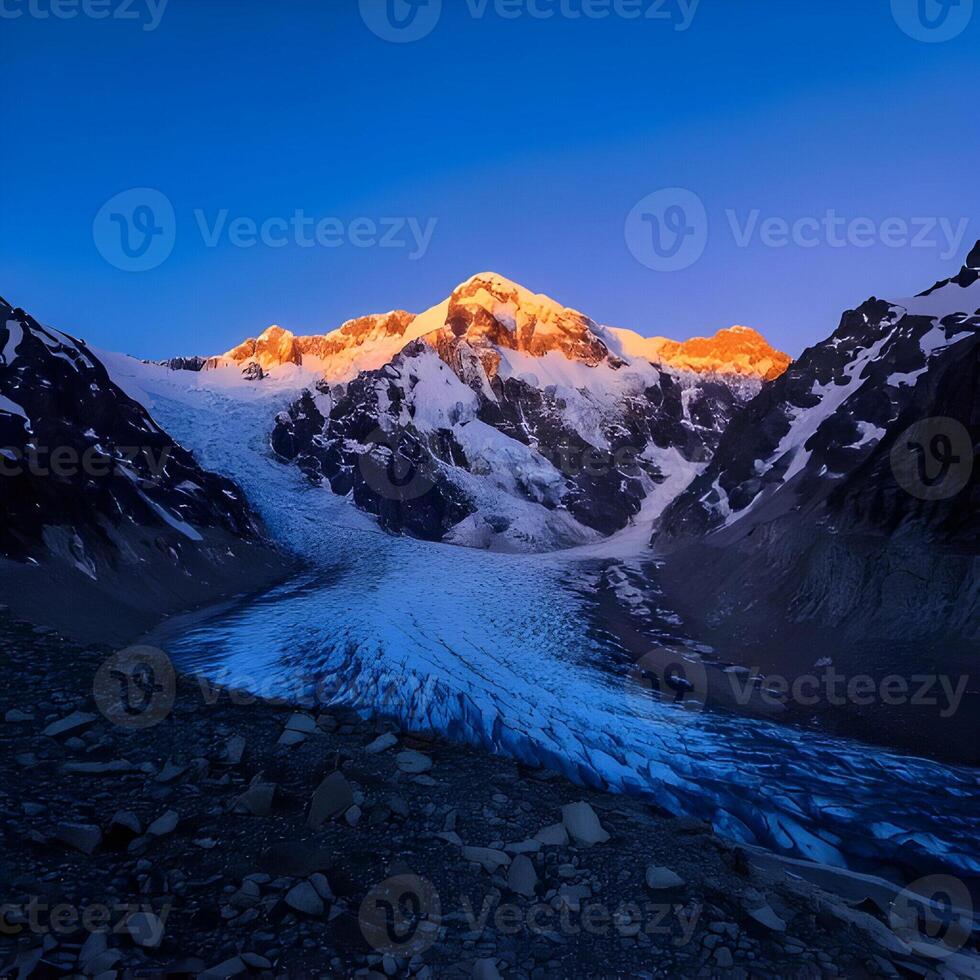 Majestic Snowcapped Mountain Peak at Sunrise photo