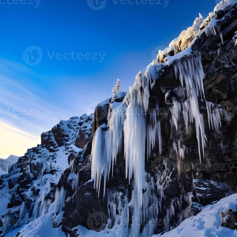 Icy Mountain Cliff Face with Hanging Icicles Under a Vivid Blue Sky photo