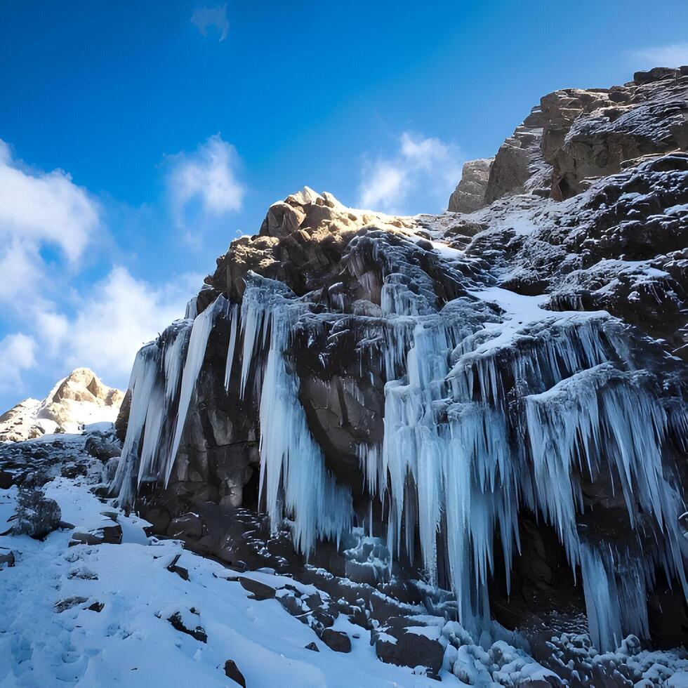Icy Waterfall on Snow Covered Mountainside photo