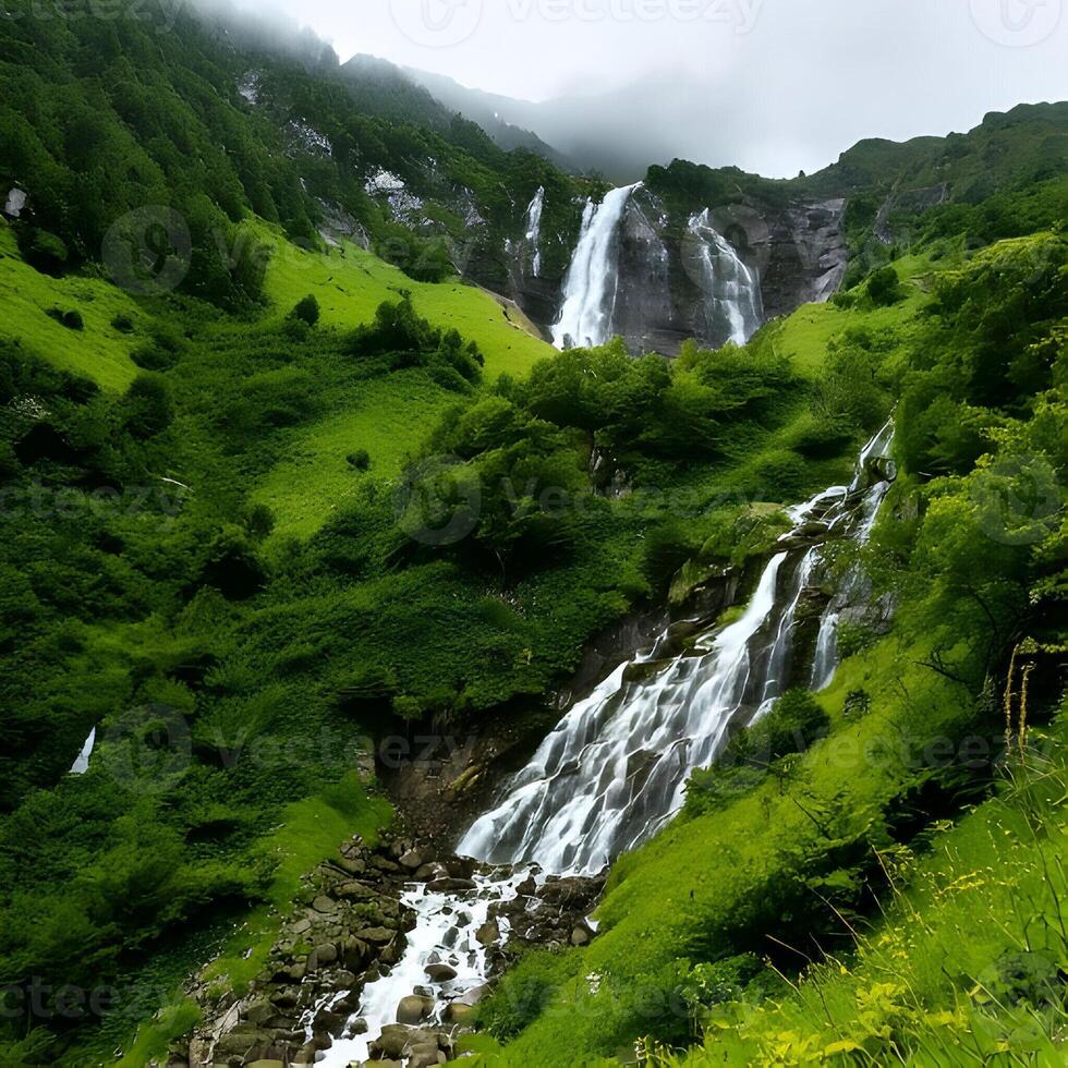 Majestic Waterfall Cascading Down Lush Green Mountains photo