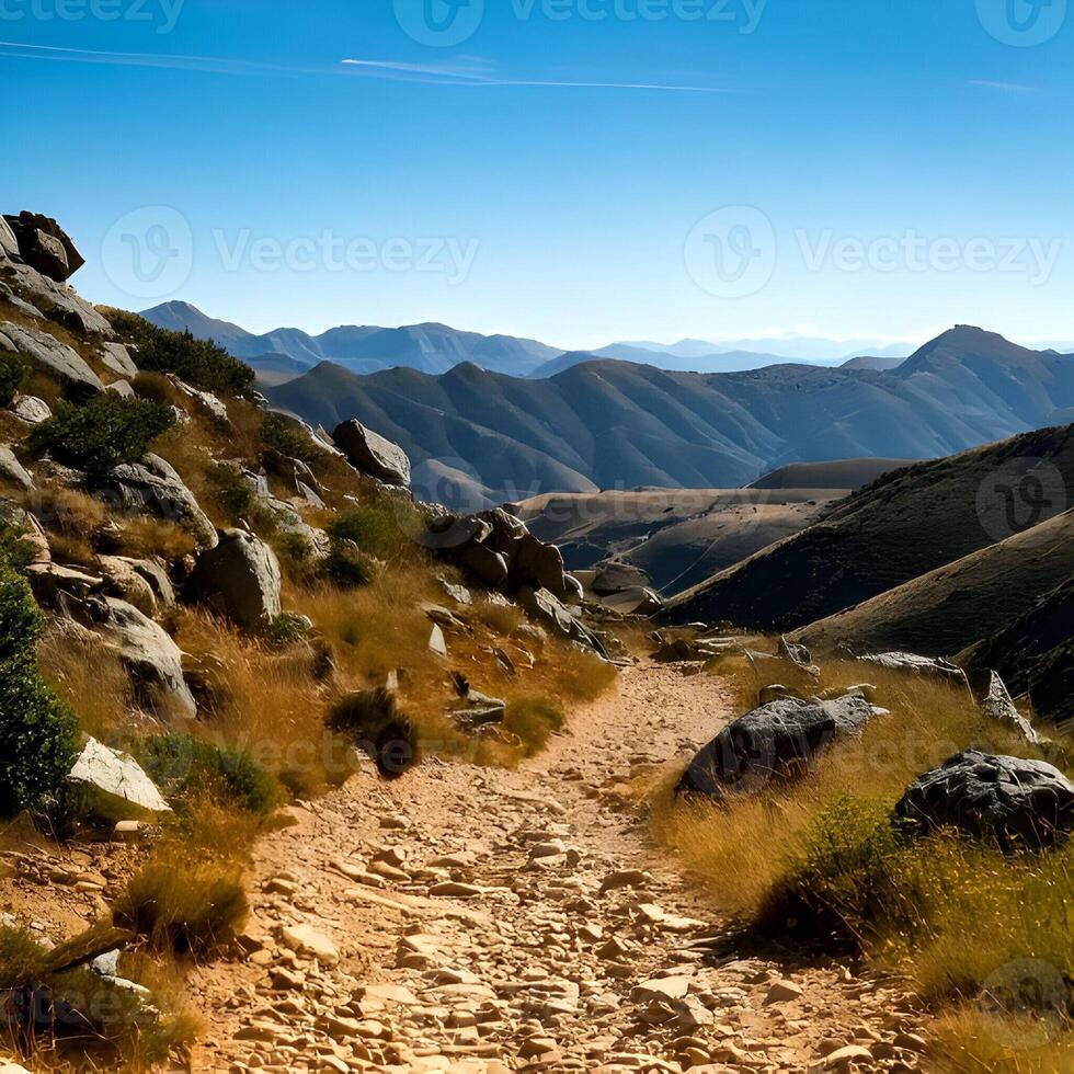 Mountain Hiking Trail Landscape with Brown Dirt Path and Rocks photo