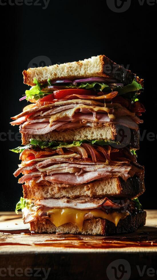 Indulgent towering sandwich stacked high with layers of turkey, cheese, and fresh vegetables in a moody kitchen setting photo