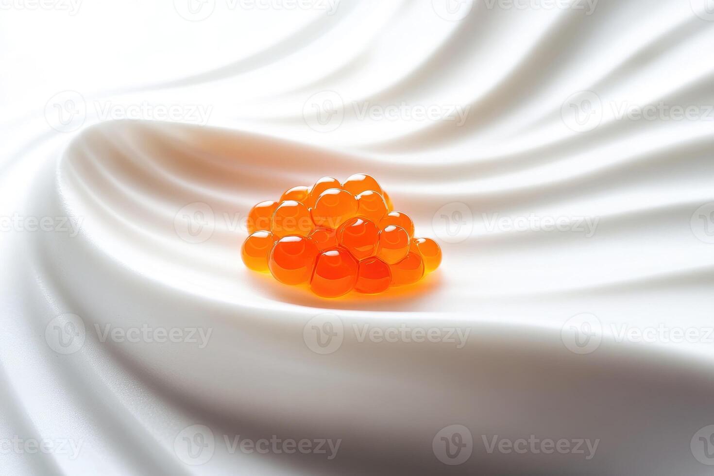 Elegant pearl of orange Osetra caviar rests on a porcelain slab with verbena foam accents for minimalistic display photo