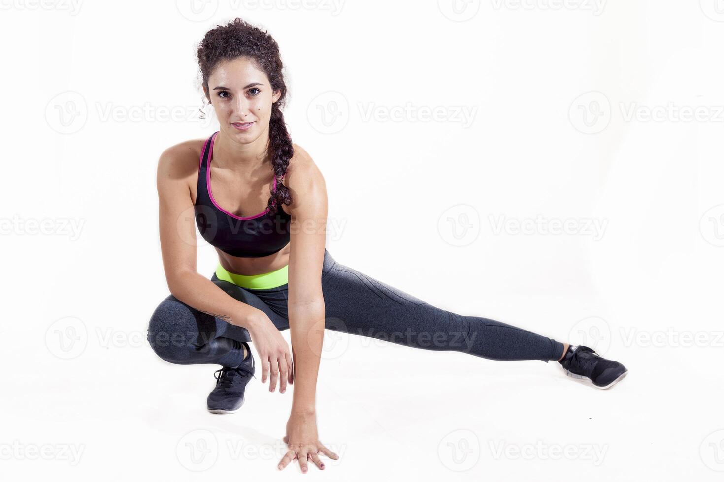 beautiful professional athlete in sportswear doing leg push-ups isolated on white background photo