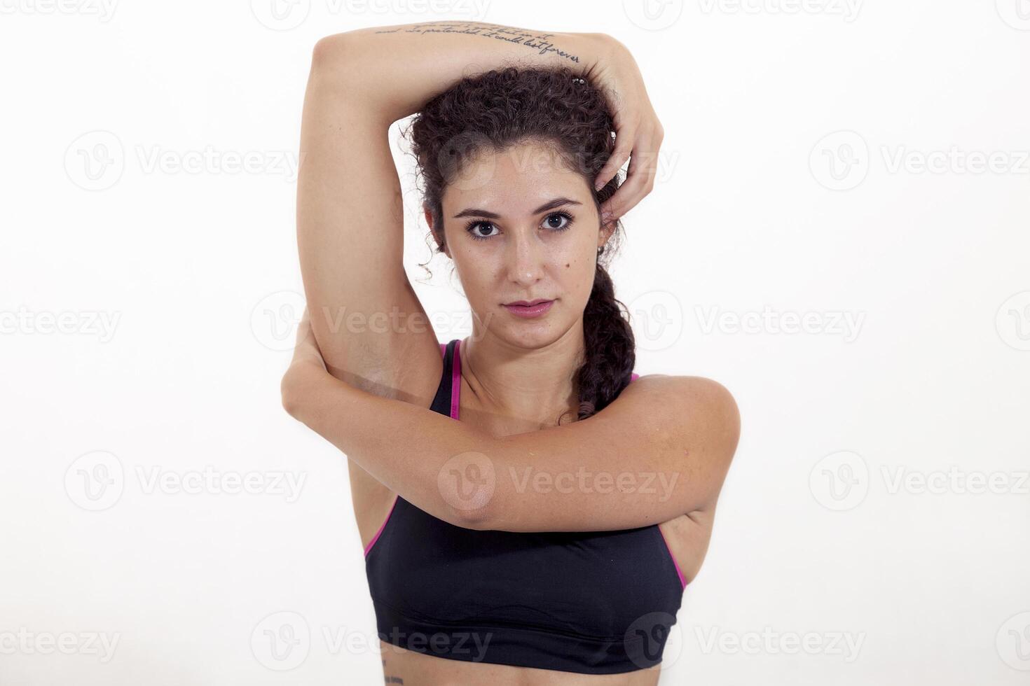 portrait of young athlete with arms crossed around head isolated on white background photo