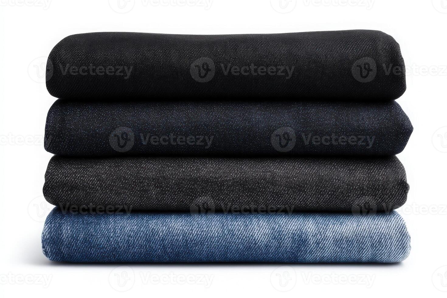 Four distinct pieces of denim fabric are stacked on top of each other, showcasing different shades of blue and black. photo