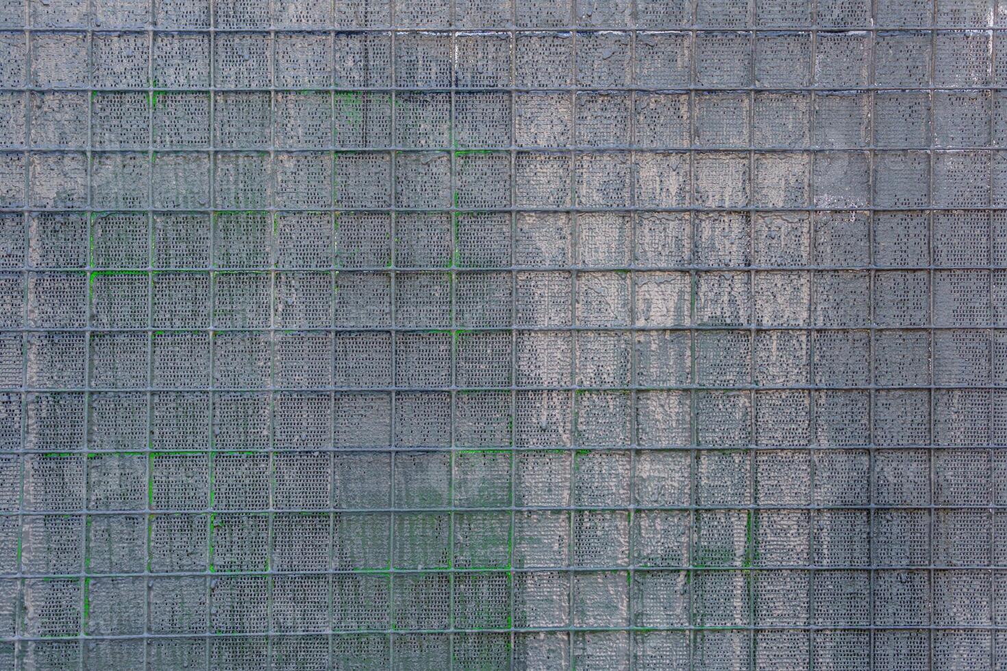 Metal mesh with large square cells painted with gray paint. Abstract artistic background. photo