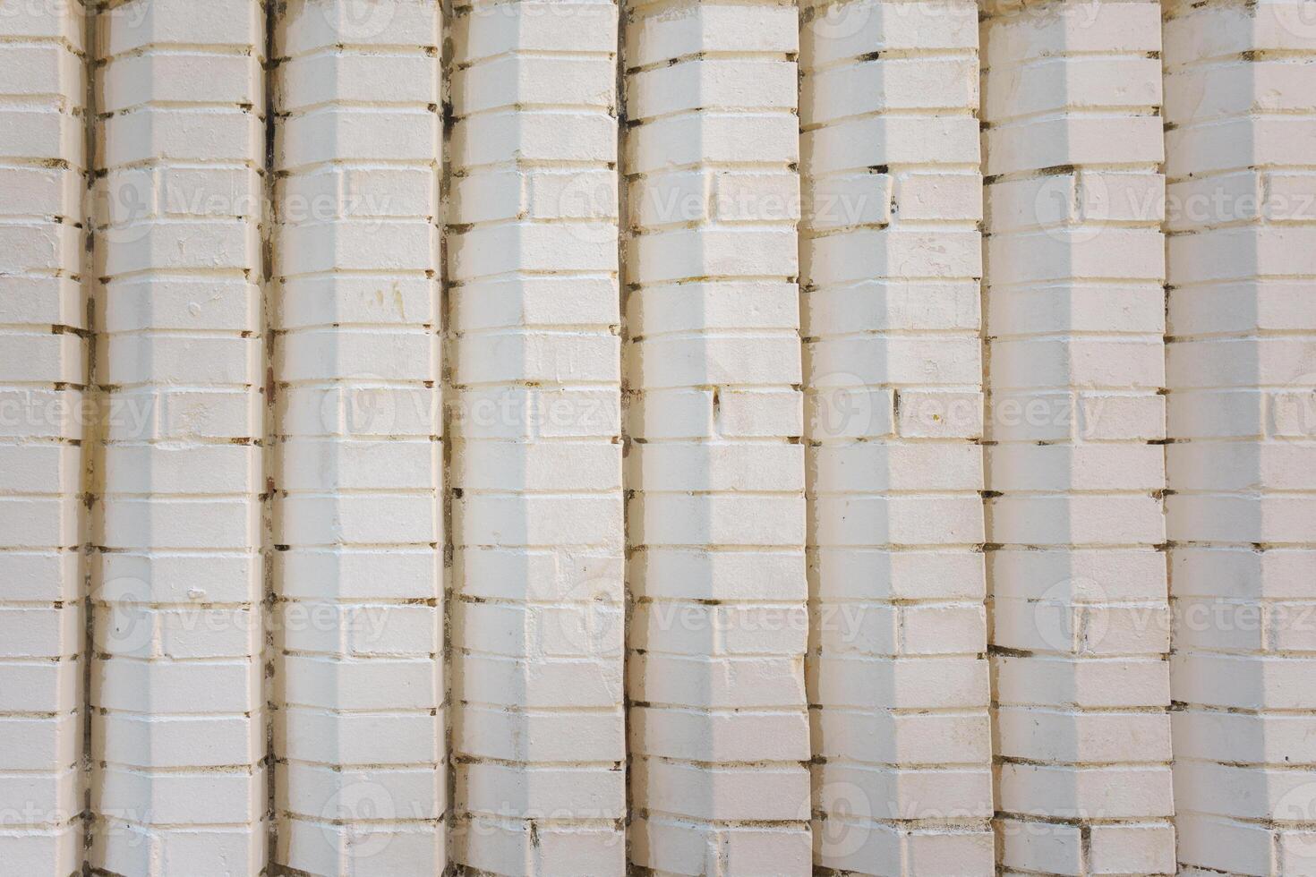 Brick vertical masonry painted white. Industrial construction background. photo