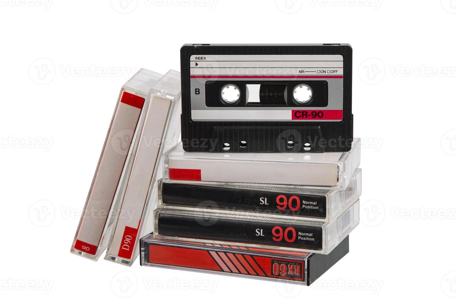 Stack of retro audio cassette tapes with one positioned upright, isolated on white back photo