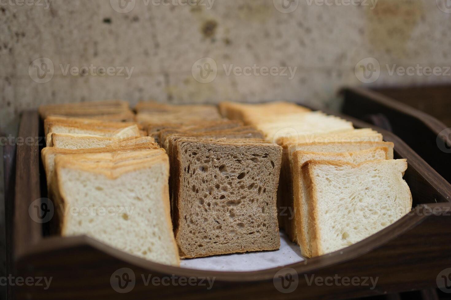 Close-up of sliced white bread and buns in wicker baskets. Perfect for projects related to baking, breakfast, or food service. Warm tones and inviting texture. photo