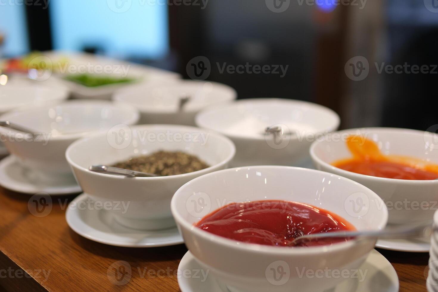 bowls of various dip sauces, top view different sauces and ingredients on gray background, flat lay. Space for text photo