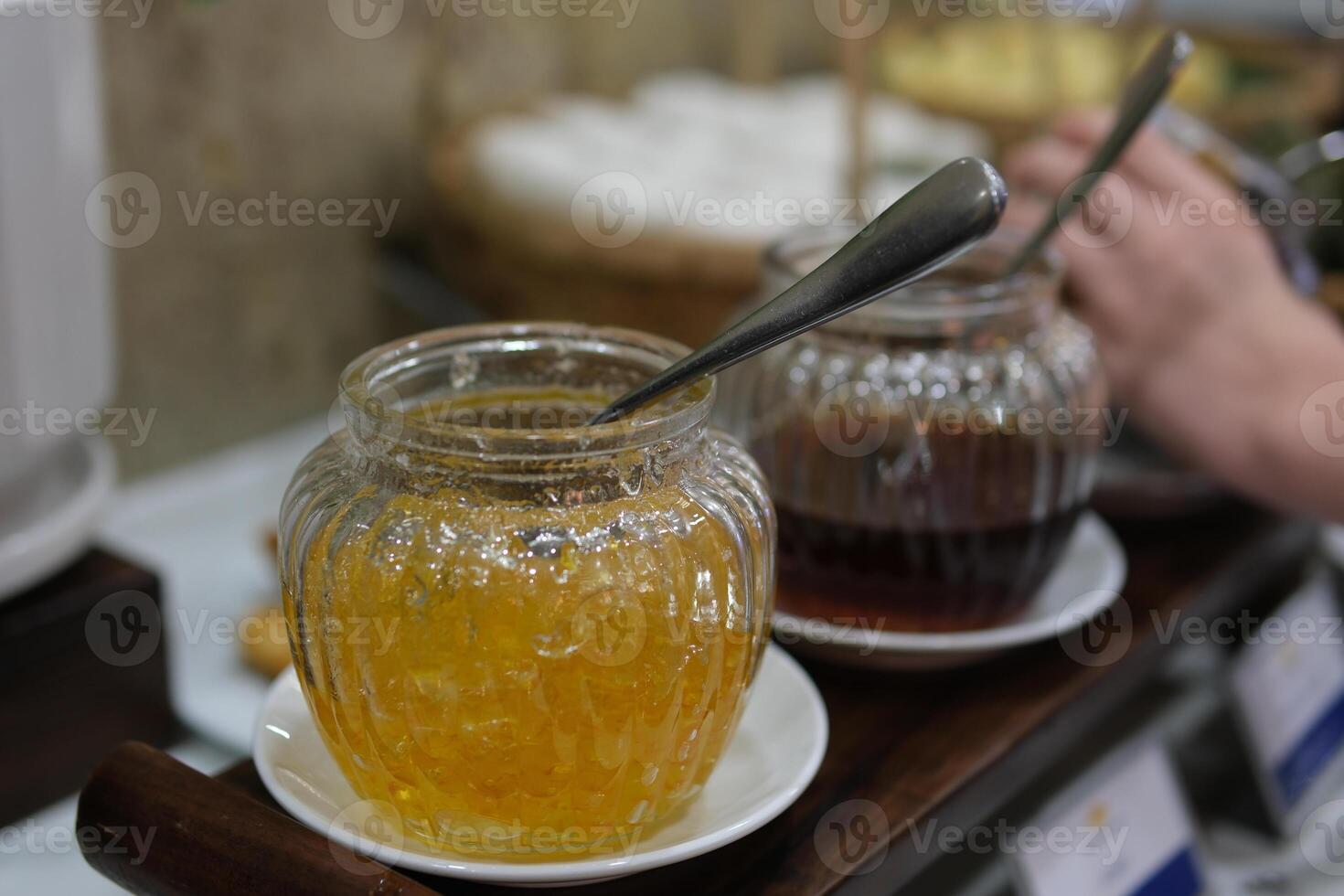 pick up yellow jam spoon picking up cooked orange jam from pan in slow motion. High quality 4k footage photo