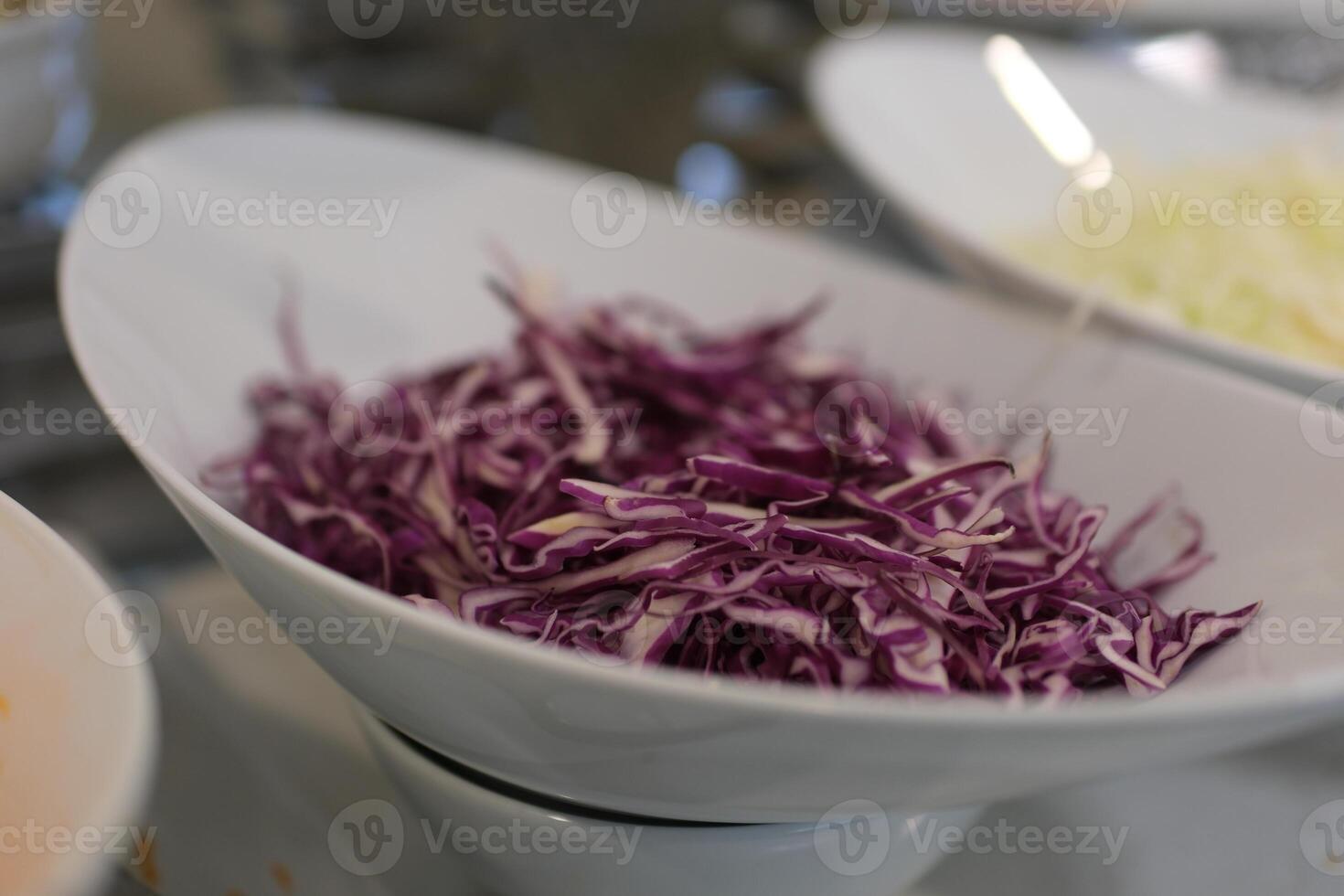 Shredded purple cabbage on wooden cutting board photo