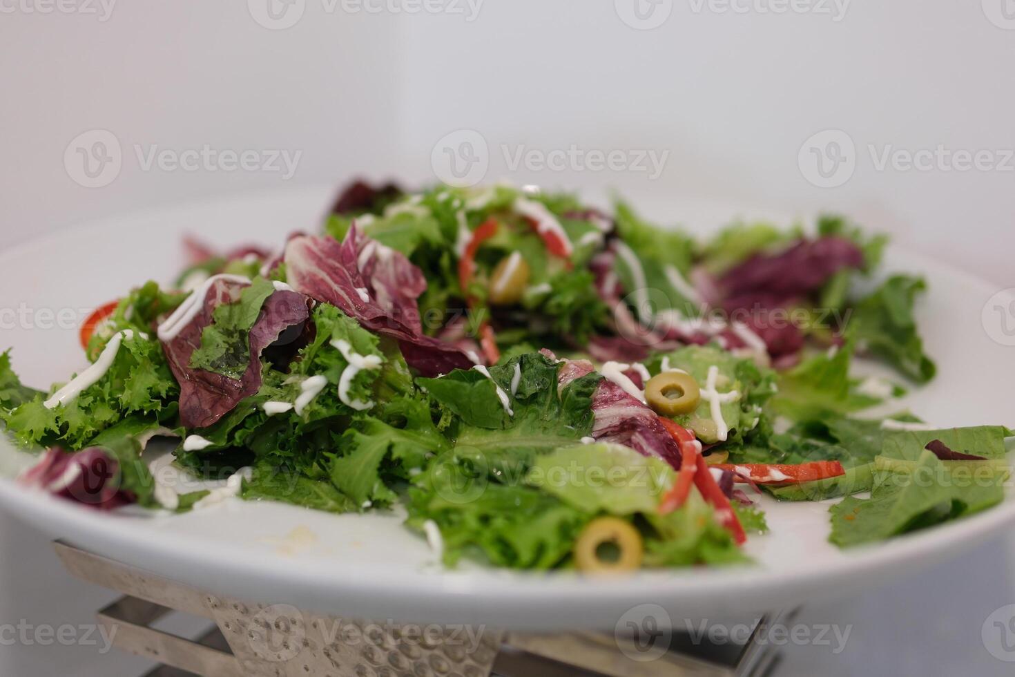 Develop healthy habits with this vibrant showing a person enjoying a fresh green salad. Ideal for promoting clean eating, gut health, and mindful nutrition. photo