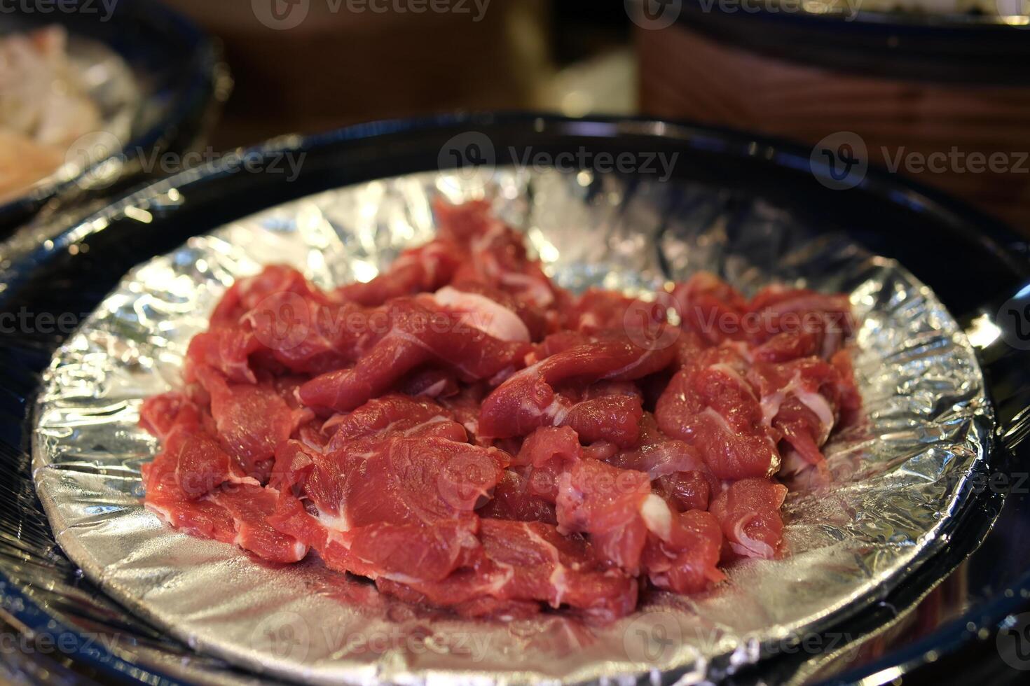 Sliced raw meat Raw pieces of beef top view, rotation. Prepare beef for cooking photo