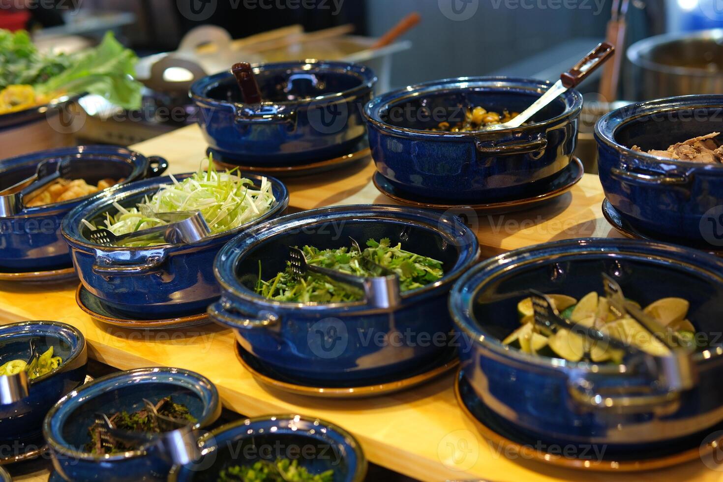 various additives in the soup buffet greens sprouted beans meat and pepper salt and other photo