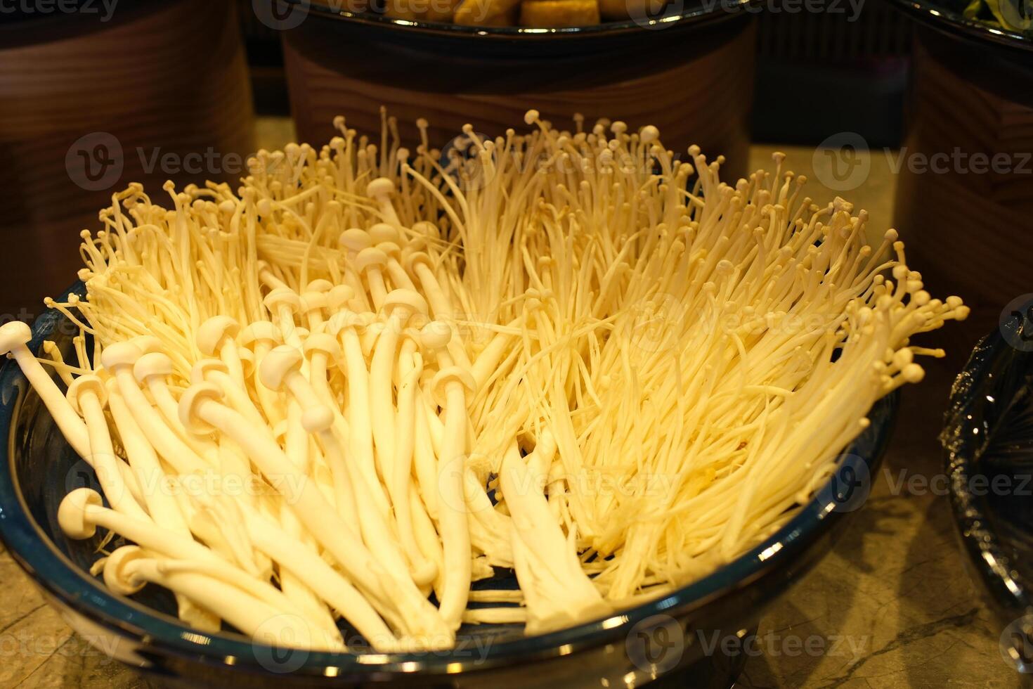 Fresh golden needle mushroom or enoki, enokitake , Flammulina velutipes in wooden plate photo