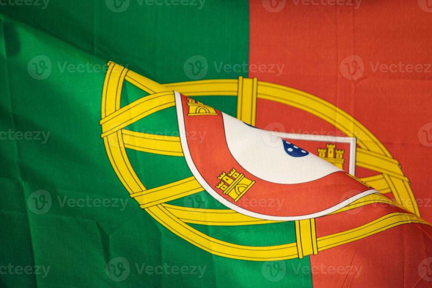 close-up view of the coat of arms on the portuguese flag detail view of the flag of portugal and national emblem photo