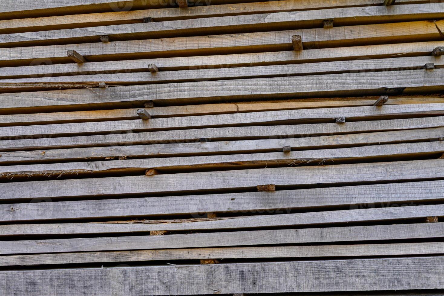 detail of raw lumber in a horizontal stack weathered wooden boards for construction sawn timber drying in layers detail of sawn timber drying in layers photo