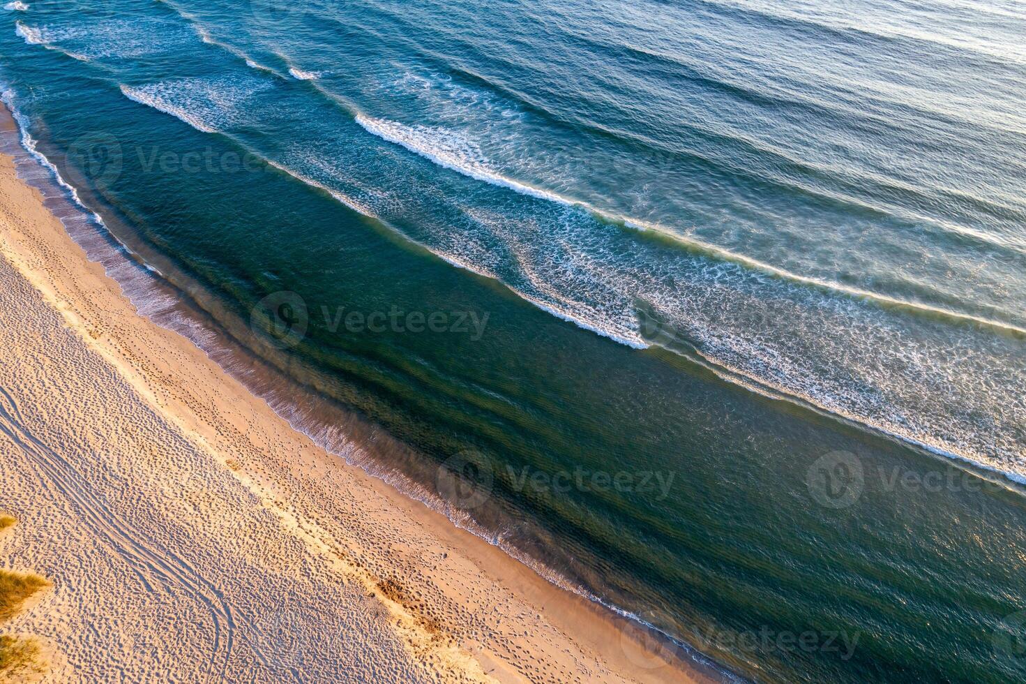mediterranean or atlantic coastline, drone top down view of nature at sunset photo
