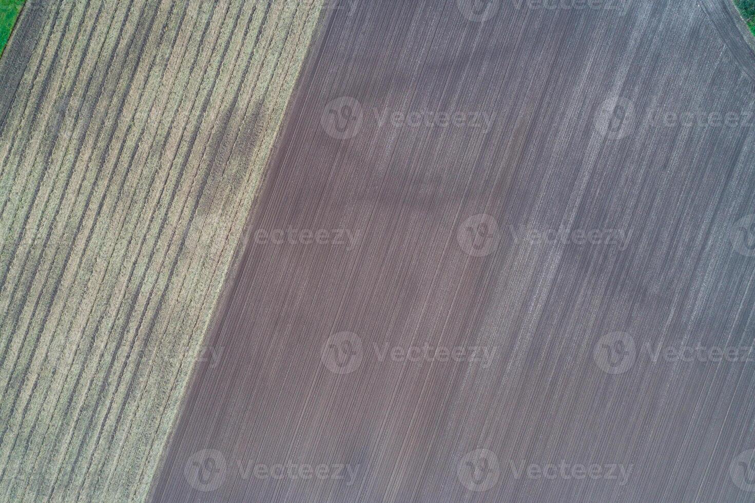 plowed field abstract background top down drone perspective photo