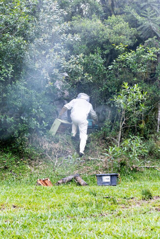 A man in a white suit is walking through a field photo
