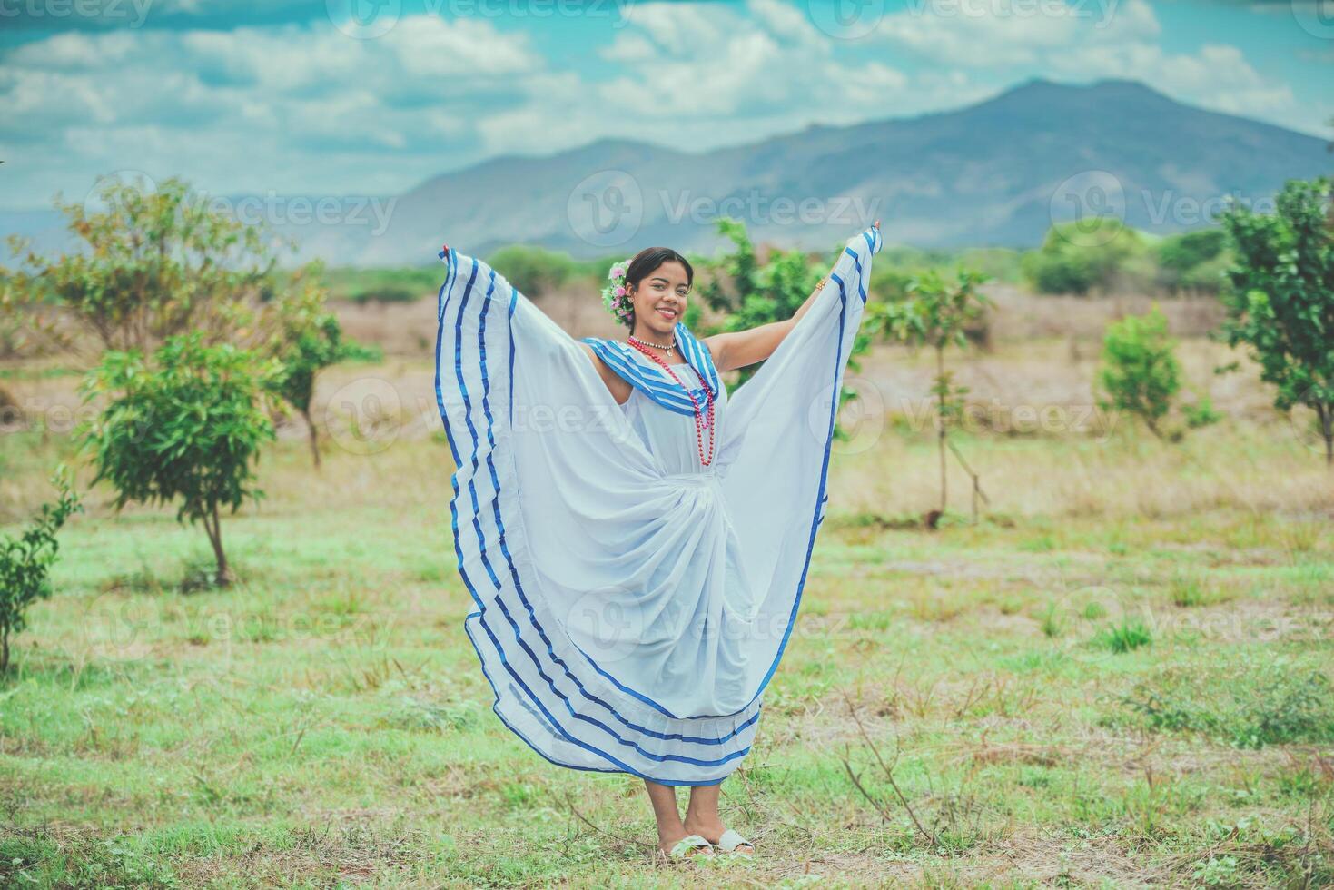 Smiling girl in national folk costume in the field. Woman wearing traditional Nicaraguan folk costume in a field photo