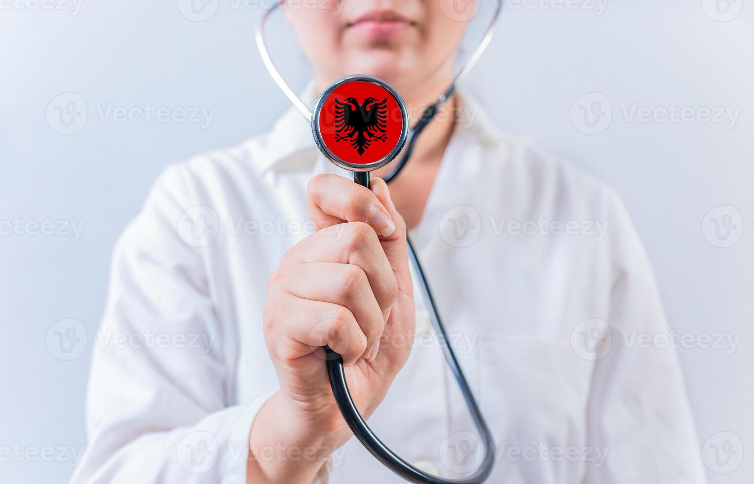 Female doctor holding stethoscope with Albania flag. National health system of Albania photo