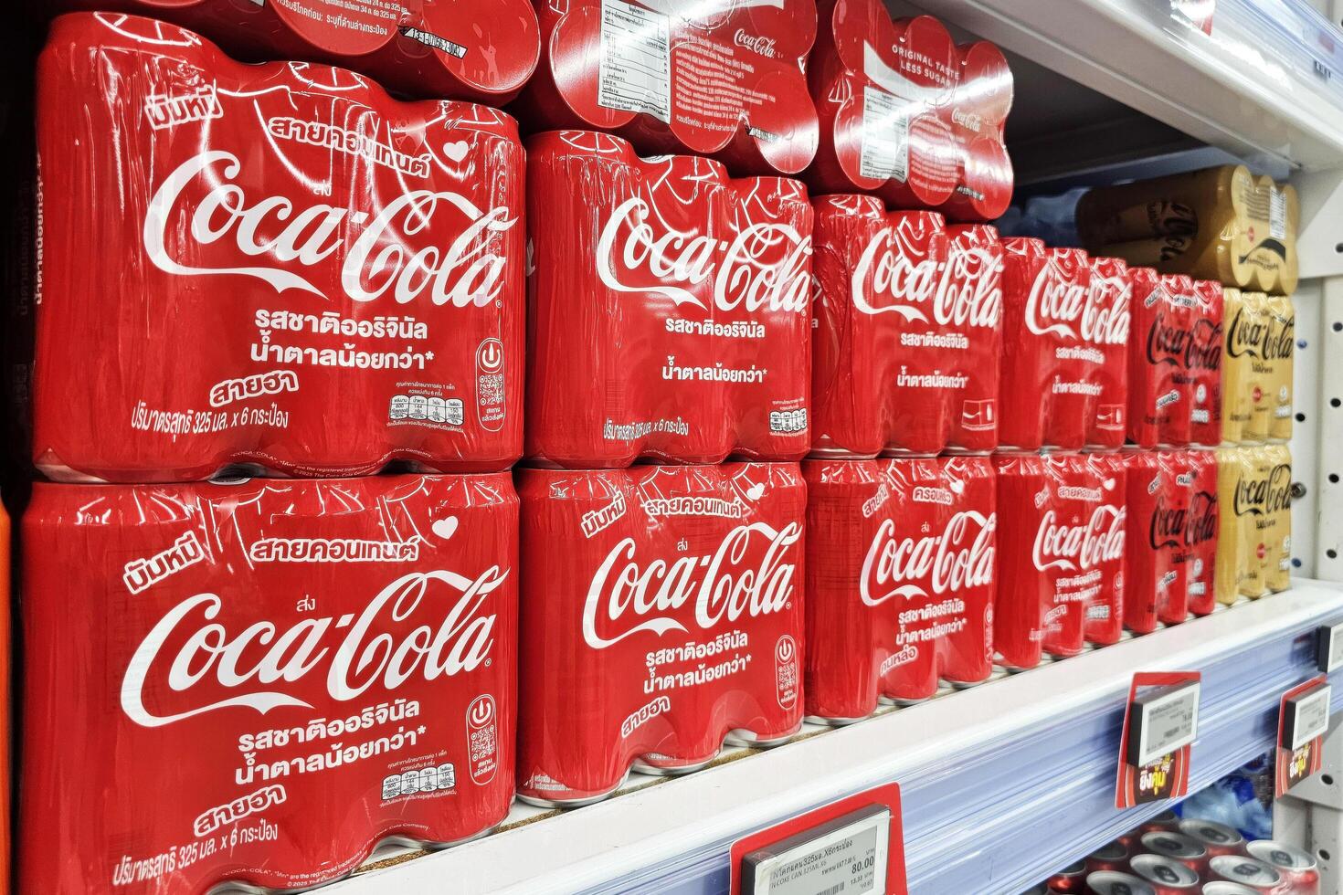Bangkok, Thailand May 11, 2025 Coca Cola cans on shelf. The Coca-Cola Company, American corporation founded in 1892. photo