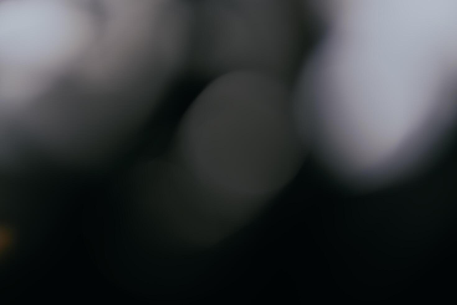White and fire silver bokeh on a black background, defocus bokeh abstract background, modern technological abstract background. White christmas background, xmas backdrop. photo