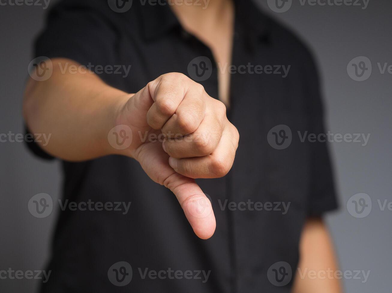 Negative concept. Close-up of businessman hand showing a thumbs down for dislike service photo