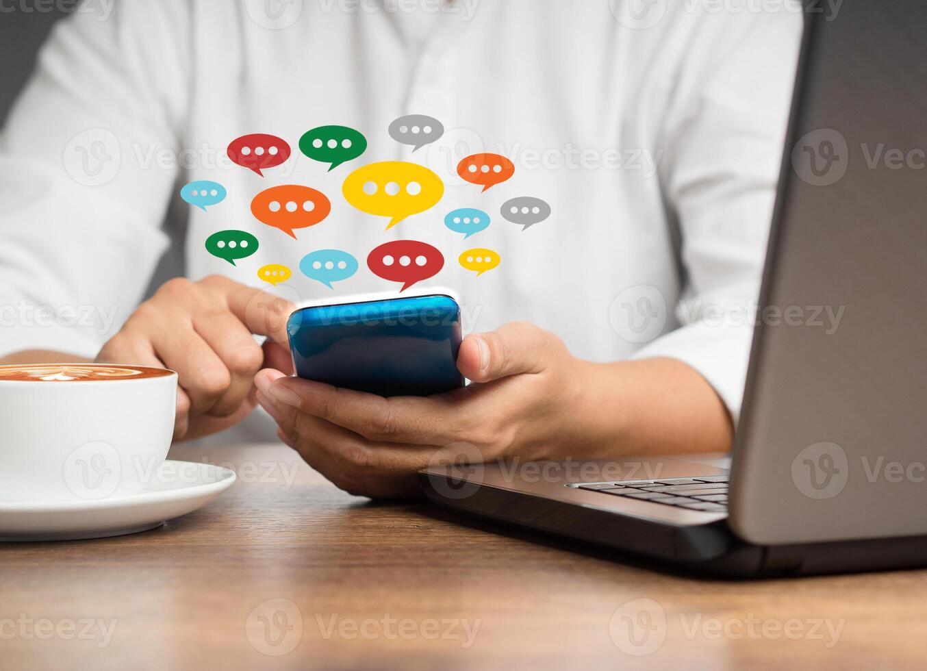 Close-up of hands using mobile phone with colorful chat icons on application communication digital photo