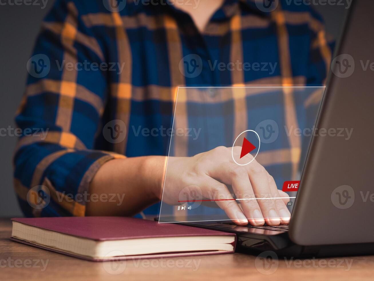 Man watches a live stream on a virtual screen with a laptop while sitting at the office photo