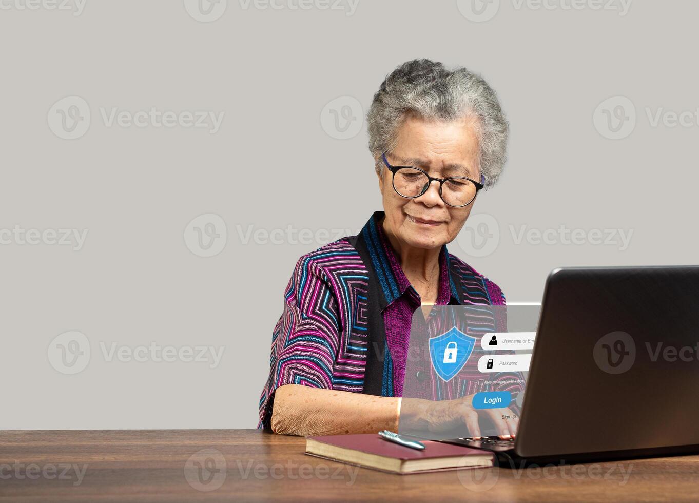 Senior woman login by username and password on the virtual screen from a laptop photo