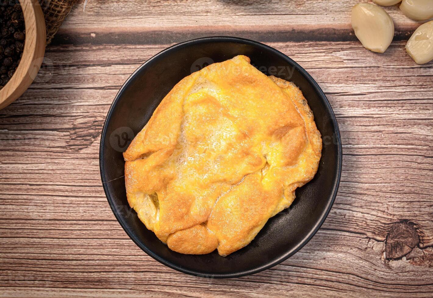 The Thai style omelet on wood table for Thai food concept. photo