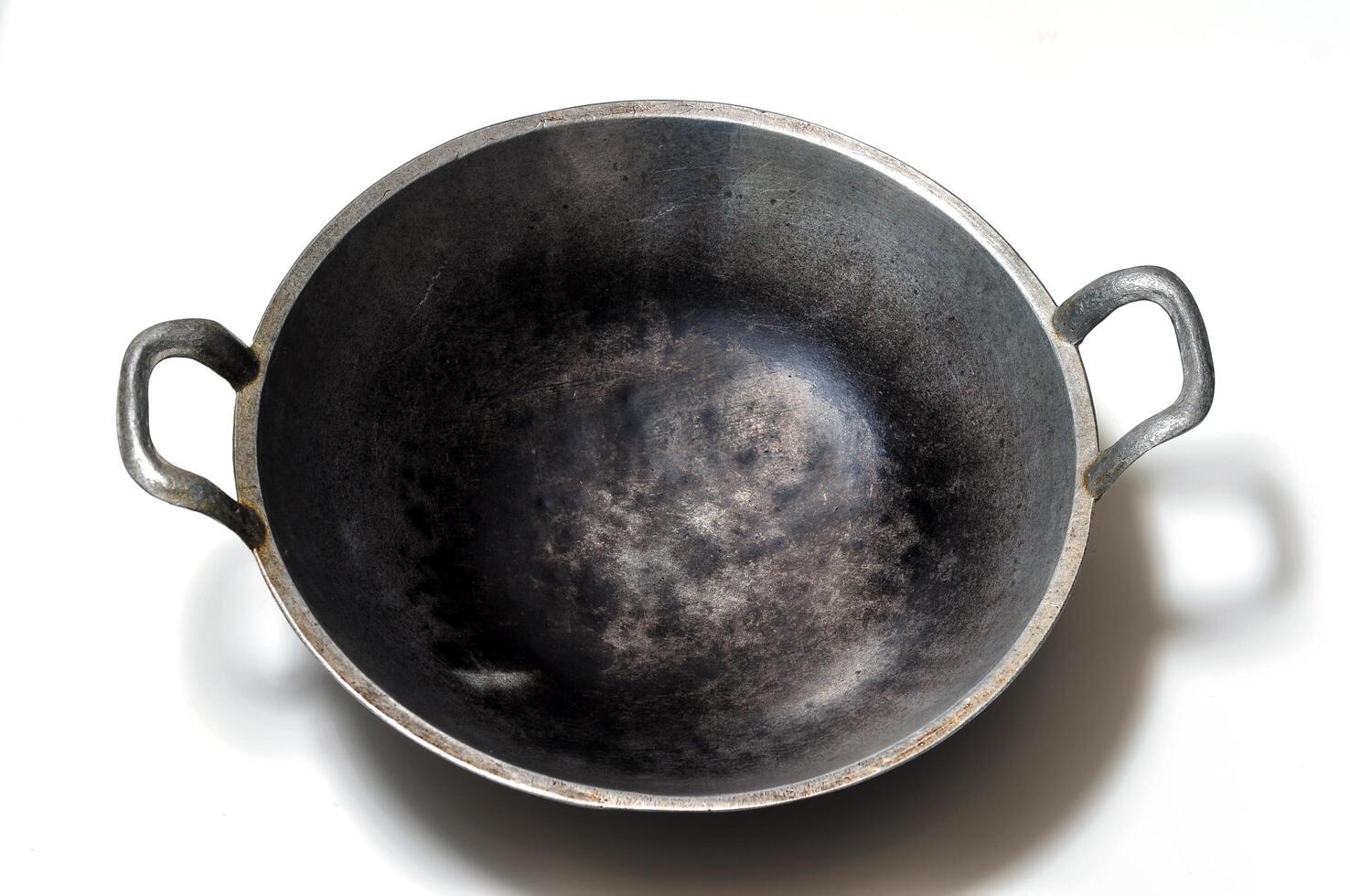 A frying pan made of aluminum that has been used frequently photo