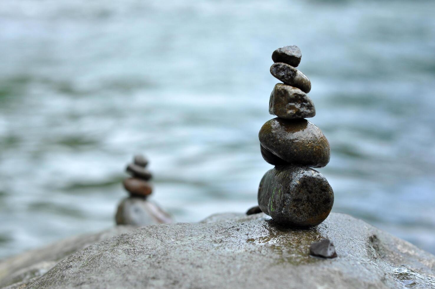 Rock stacking or rock balancing in river blur background photo