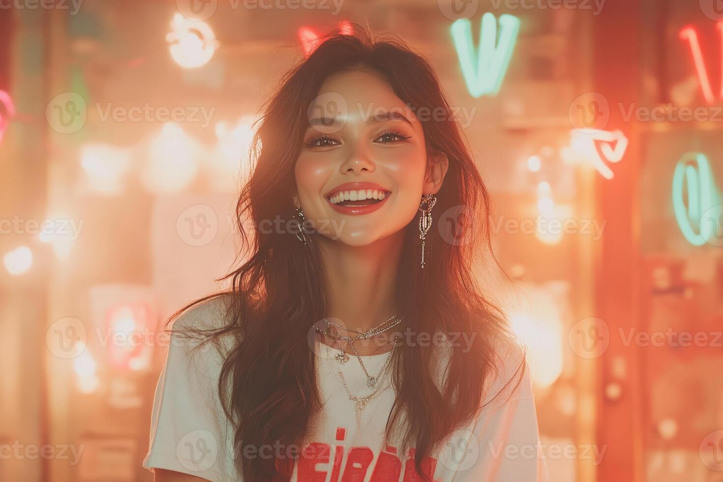 A woman smiling in front of neon lights. photo
